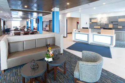 a lobby of a hospital with tables and chairs at Holiday Inn Express & Suites - North Battleford by IHG in North Battleford