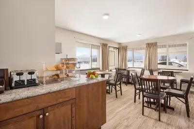 a kitchen and dining room with a table and chairs at Travelodge by Wyndham McBride in McBride