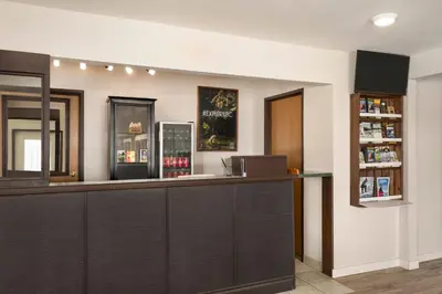 a barber shop with a dark wood counter at Travelodge by Wyndham McBride in McBride