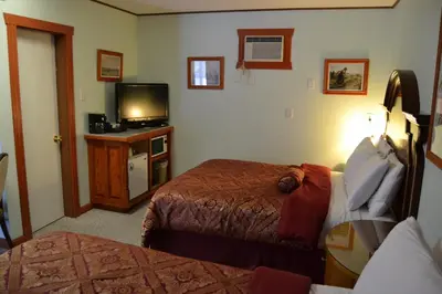 a hotel room with two beds and a television at North Star Motel in Kimberley
