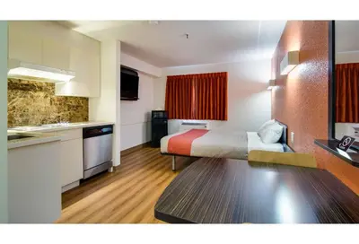 a hotel room with a bed and a kitchen at Motel 6 Kerrobert, SK in Kerrobert