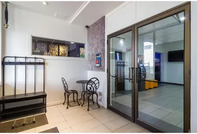 a room with a table and chairs and a glass door at Motel 6 Kerrobert, SK in Kerrobert