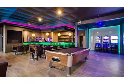 a pool table in a room with a bar at Motel 6 Kerrobert, SK in Kerrobert