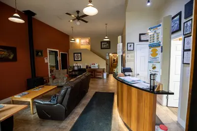 a bar with a couch and a table in a room at Northway Motor Inn in Dease Lake