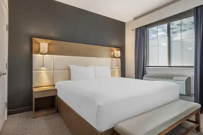 a bedroom with a large white bed and a window at Executive Residency by Best Western Calgary City View North in Calgary
