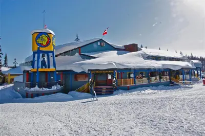 a building with a clock tower in the snow at The Bulldog Hotel in Silver Star