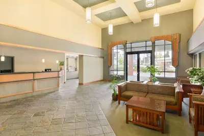 a waiting room with a couch and a table at Ramada by Wyndham Nanaimo in Nanaimo