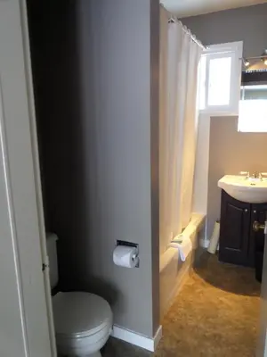 a bathroom with a toilet and a sink at Ray Lyn Motel in Trail