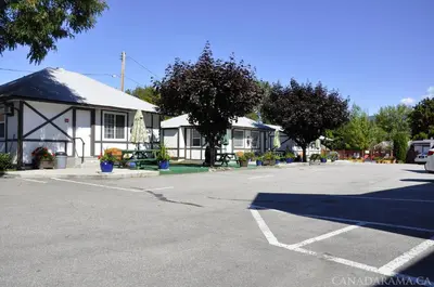 a parking lot in front of a house at Rosedale Motel in Summerland