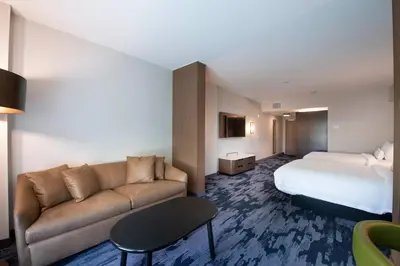 a hotel room with a bed and a couch at Fairfield by Marriott Edmonton International Airport in Edmonton