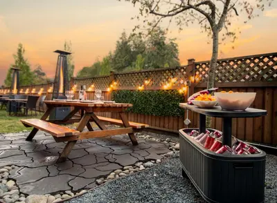 a patio with a picnic table and a grill at Coast Parksville Hotel in Parksville