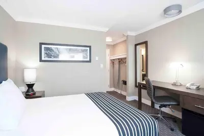 a hotel room with a bed and a desk at Sandman Inn Blue River in Blue River