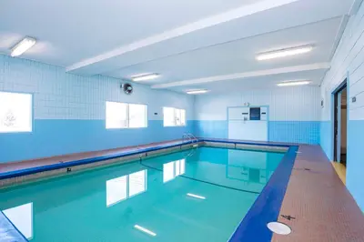 a large swimming pool with blue walls and blue tiles at Sandman Hotel Cranbrook in Cranbrook