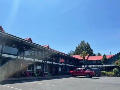 a red truck parked in front of a building at Schooner Motel in Tofino