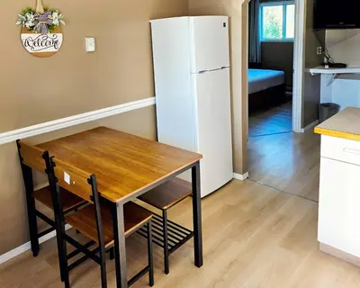 a kitchen with a table and a white refrigerator at Skimmerhorn Inn in Creston