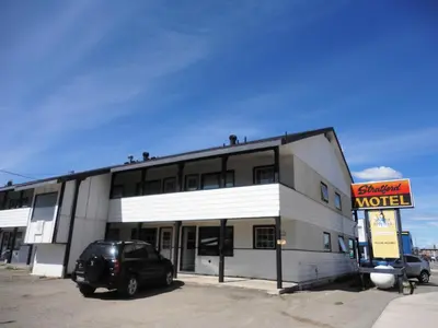 a truck parked in front of a motel at Stratford Motel in Whitehorse