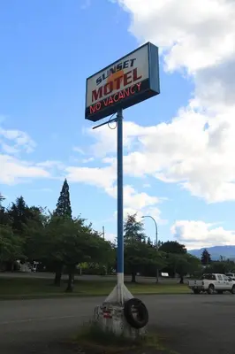a sign for a motel no vacancy on a street at Sunset Motel & Trailer Park, Incorporated in Port Alberni