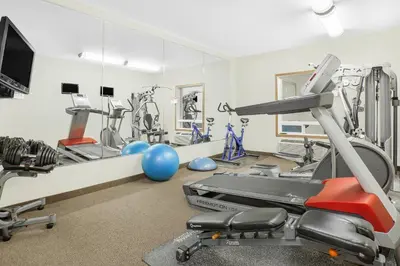 a gym with cardio equipment and a treadmill at Super 8 by Wyndham Athabasca AB in Athabasca