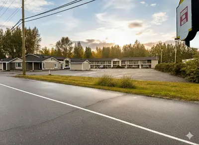 an empty road in front of a motel at Quesnel Inn in Quesnel