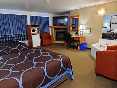 a hotel room with a bed and a desk at Super 8 by Wyndham Three Hills AB in Three Hills