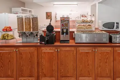 a kitchen with a counter with food on it at Super 8 by Wyndham Three Hills AB in Three Hills