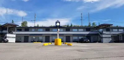 a building with a clock tower in a parking lot at Howard Johnson by Wyndham Hinton in Hinton