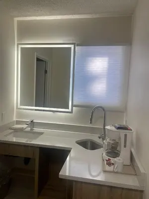 a bathroom counter with a sink and a mirror at Howard Johnson by Wyndham Hinton in Hinton
