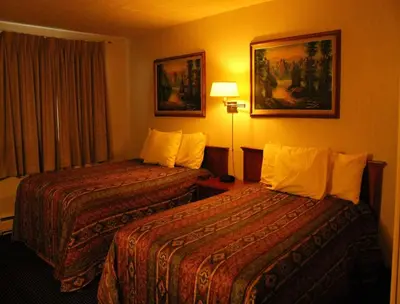 a hotel room with two beds and a window at Tel Star Motel in Brooks