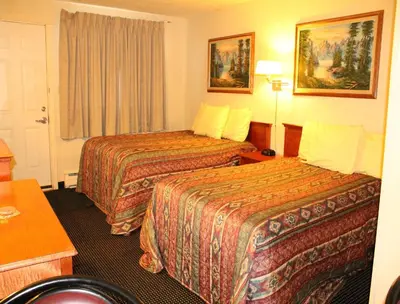 a hotel room with two beds and a window at Tel Star Motel in Brooks