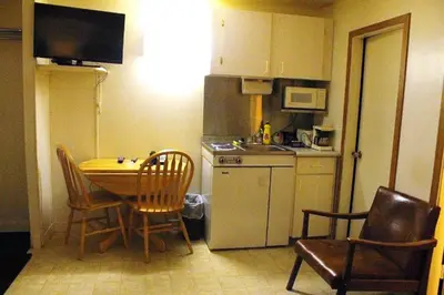 a kitchen with a table and chairs and a kitchen with a sink at Tel Star Motel in Brooks