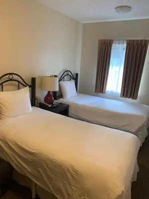 a hotel room with two beds and a window at Barclay Hotel in Vancouver