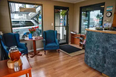 a room with chairs and a bar in a store at Thunderbird Motor Inn in Duncan