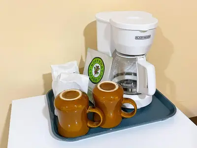 a tray with two coffee mugs and a coffee maker at Valhalla Inn in New Denver