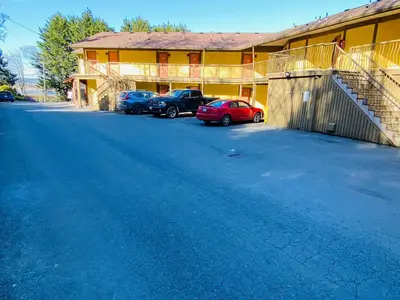 a group of cars parked in front of a building at Wessex Inn By The Sea in Cowichan Bay