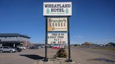 a sign in a parking lot for a wheatland hotel at Wheatland Hotel in Strathmore