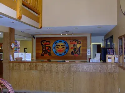 a restaurant counter with a mural on the wall at The Yukon Inn in Whitehorse