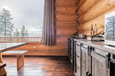 a wooden cabin with a bench and a window at Spirit Lodge at Silverstar in Vernon