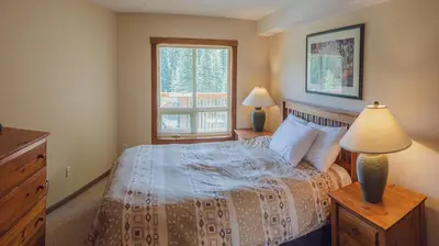 a bedroom with a bed and a window at Fireside Lodge #419 By Bear Country in Sun Peaks