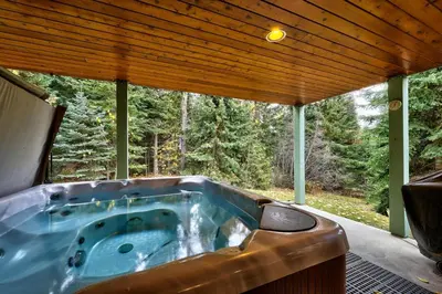 a jacuzzi tub in the middle of a house at Snow Creek Village #37 By Bear Country in Sun Peaks