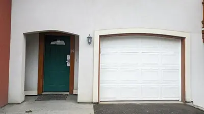 a pair of garage doors and a green door at Timberline Village #38 By Bear Country in Sun Peaks