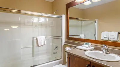 a bathroom with a shower and a sink at Woodhaven #32 By Bear Country in Sun Peaks