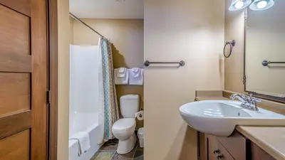 a small bathroom with a sink and a toilet at Stones Throw #11 By Bear Country in Sun Peaks