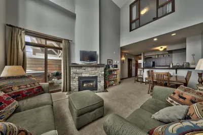 a living room with a couch and a fireplace at Stones Throw #56 By Bear Country in Sun Peaks