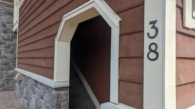 a garage with a number on the side of a house at Stones Throw #38 By Bear Country in Sun Peaks