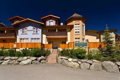 a large house with a sign in front of it at Crystal Forest #72 By Bear Country in Sun Peaks
