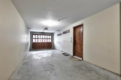 an empty room with a door and a hallway at Trappers Landing #11 By Bear Country in Sun Peaks
