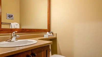 a bathroom with a sink and a mirror at Trappers Landing #06 By Bear Country in Sun Peaks