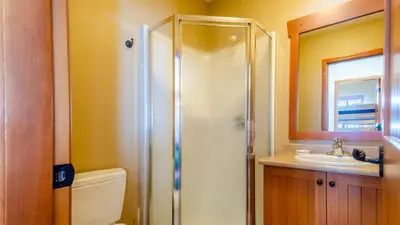 a bathroom with a shower and a toilet and a sink at Trails Edge #03 By Bear Country in Sun Peaks