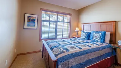 a bedroom with a bed and a window at Trails Edge #03 By Bear Country in Sun Peaks
