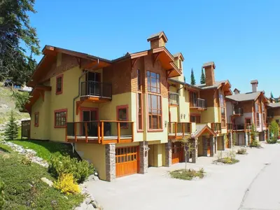 a large house with balconies on a street at Trails Edge #03 By Bear Country in Sun Peaks